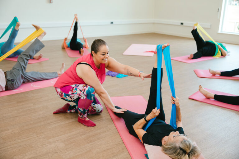 leanne English from mobilates providing an exercise class with bands for stretching legs
