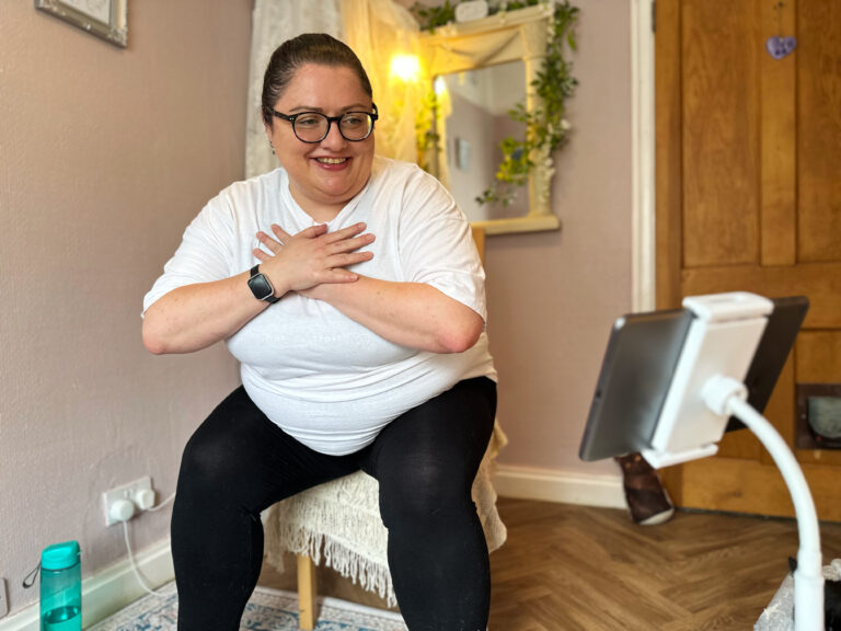 a mobilates member doing an exercise from a chair