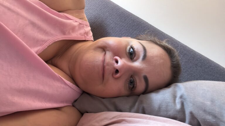 Leanne lying on her bed looking glum