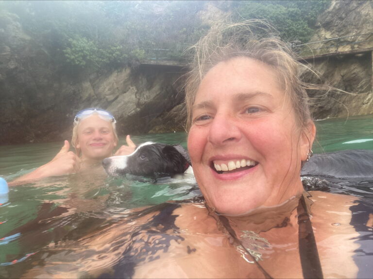 Jodie smiling at the camera in the water.