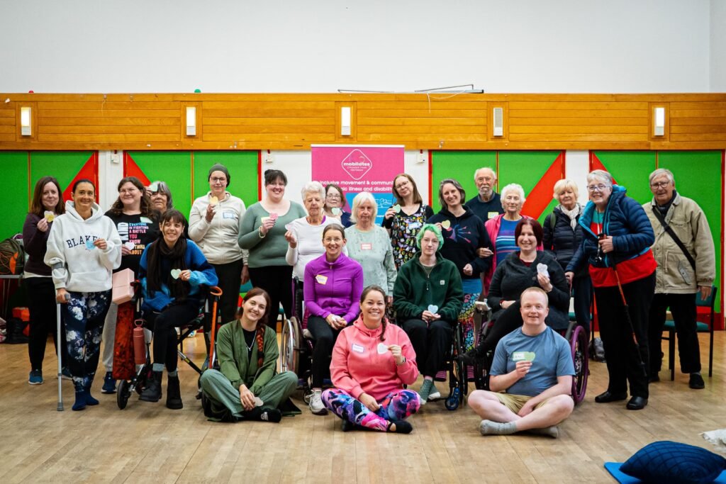 Team mob and members of our community all standing and sitting together at the end of the Wonford retreat day, smiling and sharing special notes written for each other