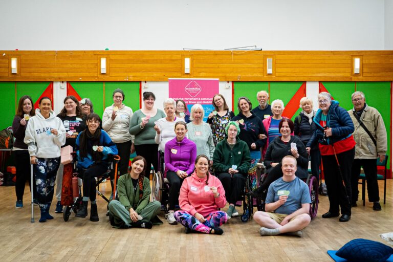 Team mob and members of our community all standing and sitting together at the end of the Wonford retreat day, smiling and sharing special notes written for each other