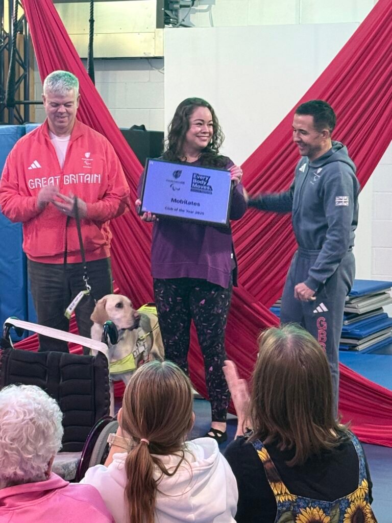 Leanne standing in between Will and Dave being presented with the Everybody Moves Club of The Year Award